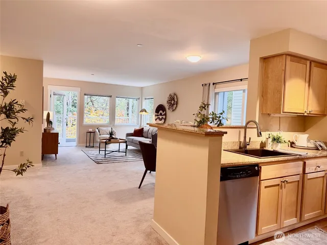 a kitchen with stainless steel appliances a stove a sink and a refrigerator