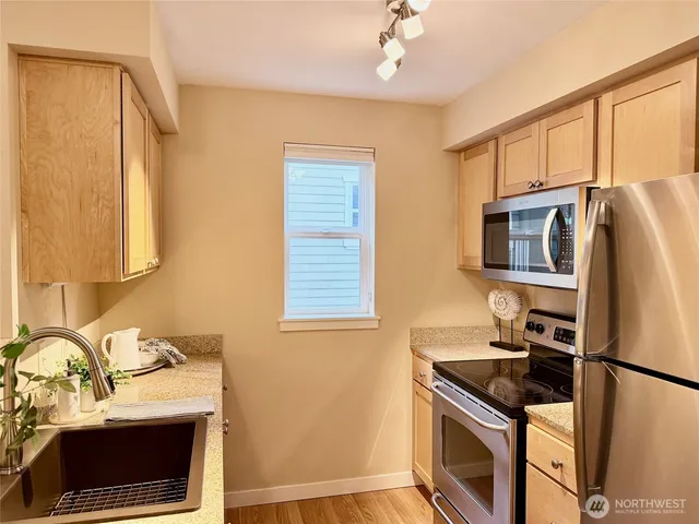 a living room with a couch and a dining table with painted walls