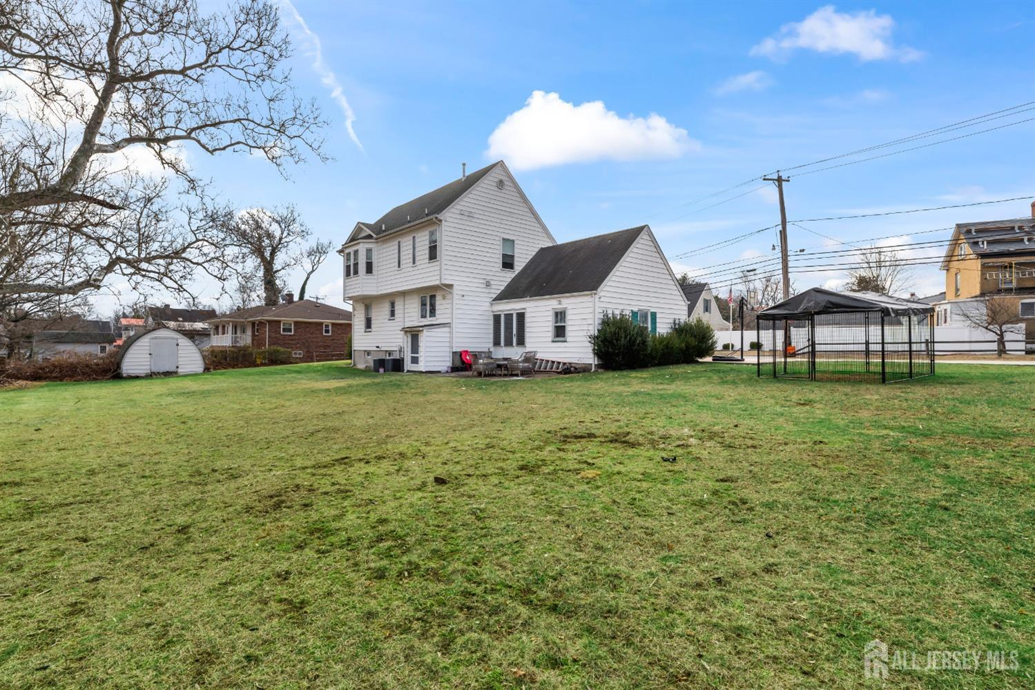 28 River Road East Brunswick, NJ 08816 - Photo 3 of 46 a view of a house with a big yard and large trees