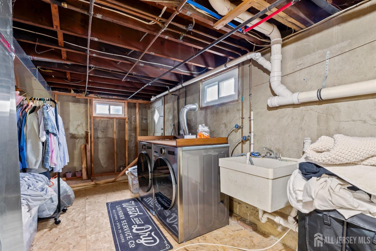 28 River Road East Brunswick, NJ 08816 - Photo 34 of 46 a utility room with dryer washer and a view of living room
