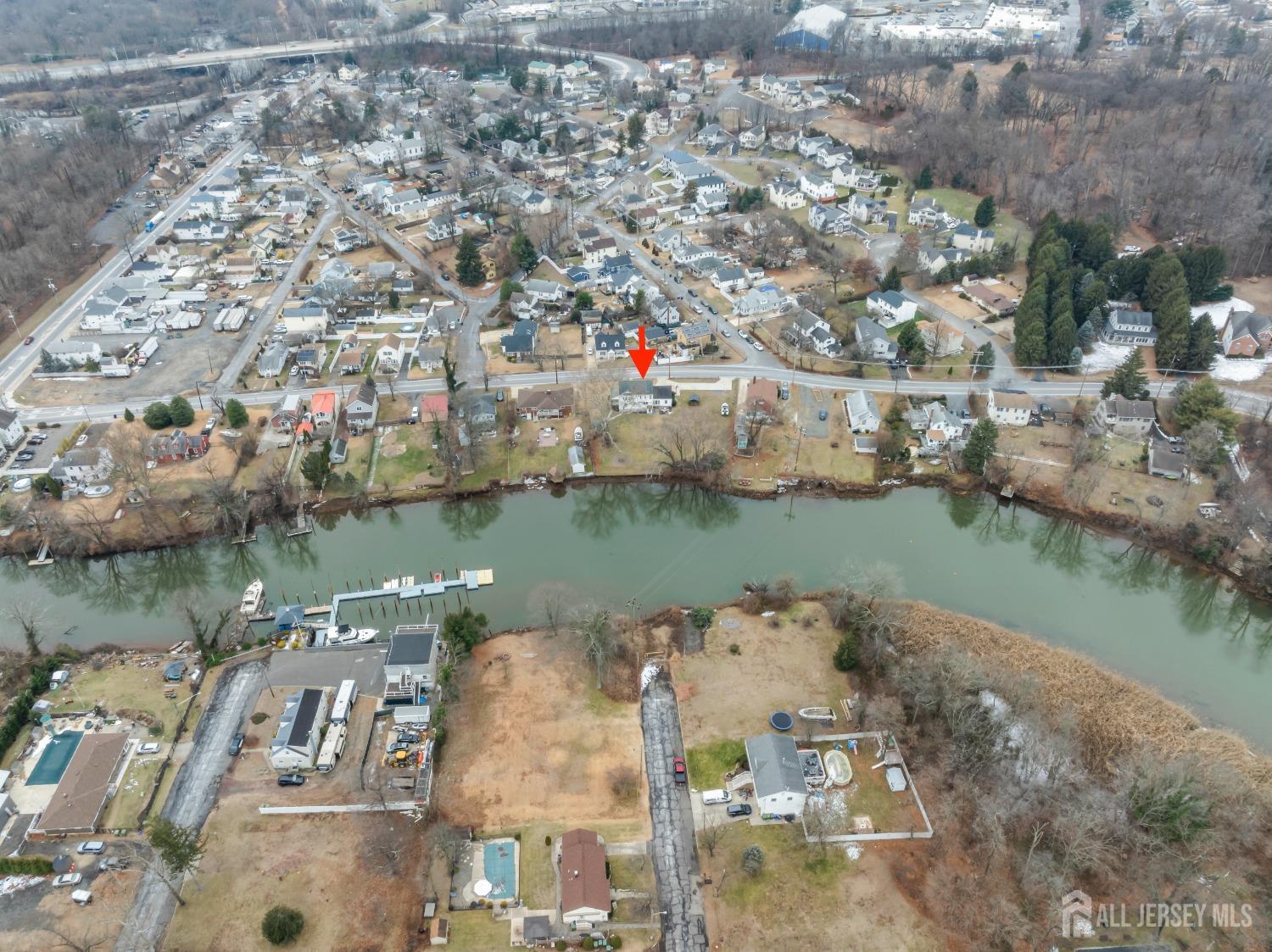 28 River Road East Brunswick, NJ 08816 - Photo 42 of 46 an aerial view of lake residential house with outdoor space and swimming pool