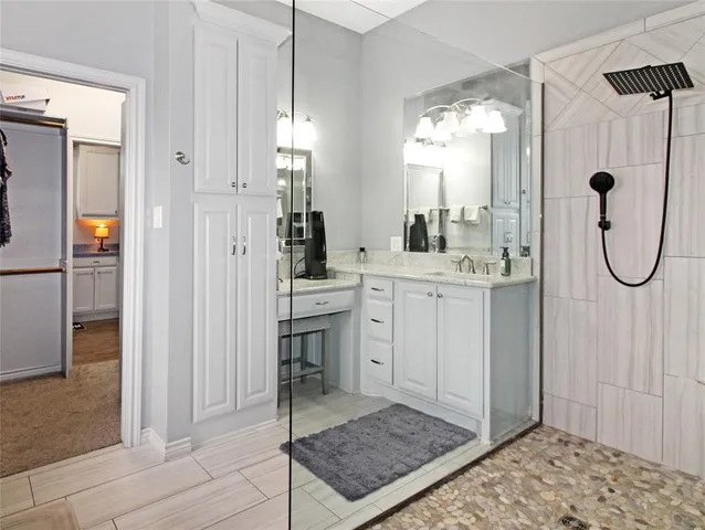 a bathroom with a sink a mirror and a shower