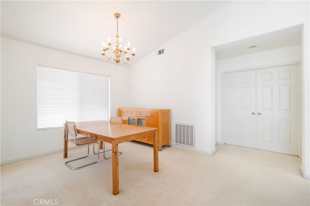 a view of a room with furniture and a chandelier