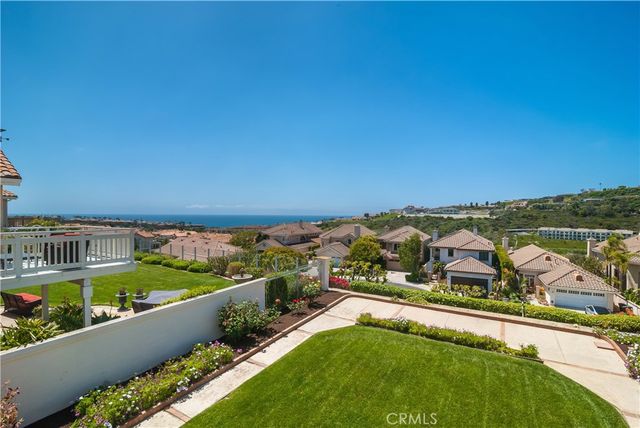 an aerial view of residential houses with outdoor space and swimming pool