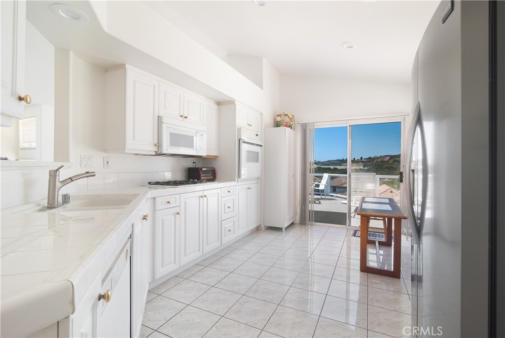 51 Santa Lucia Dana Point, CA 92629 - Photo 7 of 50 a kitchen with stainless steel appliances granite countertop a refrigerator and a sink