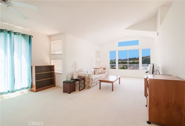 a living room with furniture and large windows