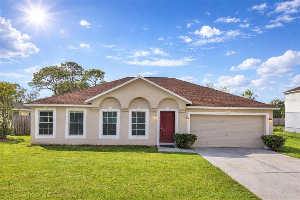 12052 Villa Road Spring Hill, FL 34609 - Photo 1 of 50 a front view of a house with a garden