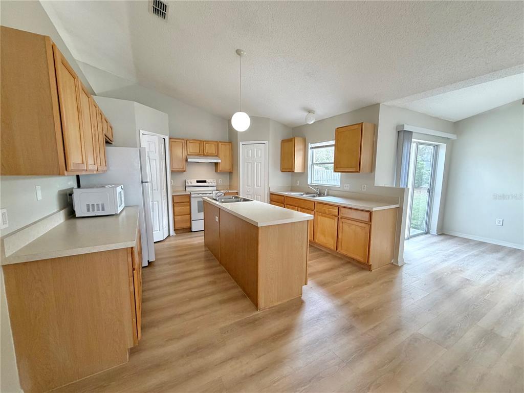 12052 Villa Road Spring Hill, FL 34609 - Photo 12 of 50 a large kitchen with a lot of counter space and a sink