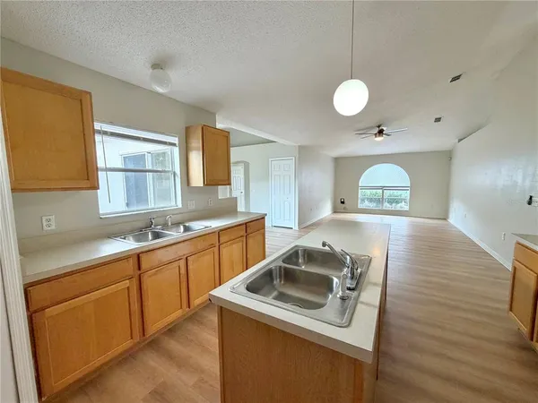 a kitchen that has a sink and a stove in it