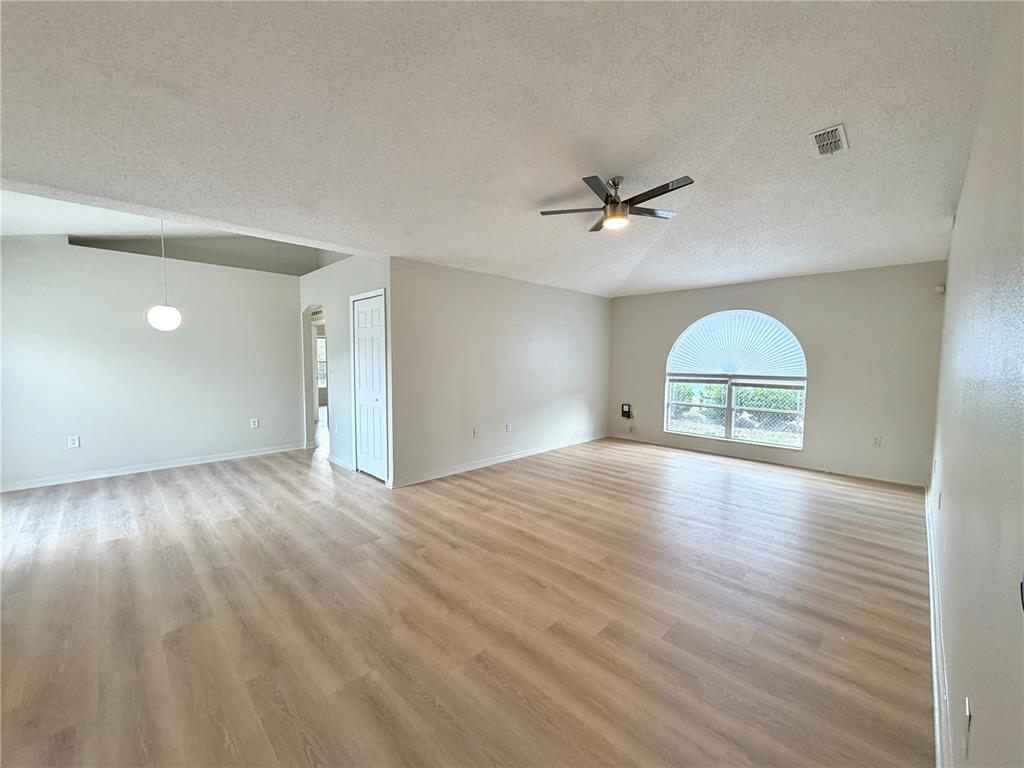 12052 Villa Road Spring Hill, FL 34609 - Photo 14 of 50 wooden floor in an empty room with a window