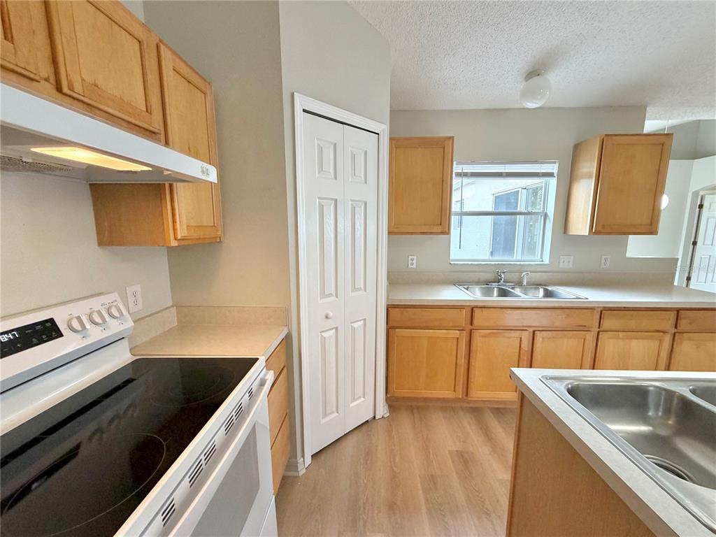12052 Villa Road Spring Hill, FL 34609 - Photo 19 of 50 a kitchen with granite countertop a sink stove and cabinets