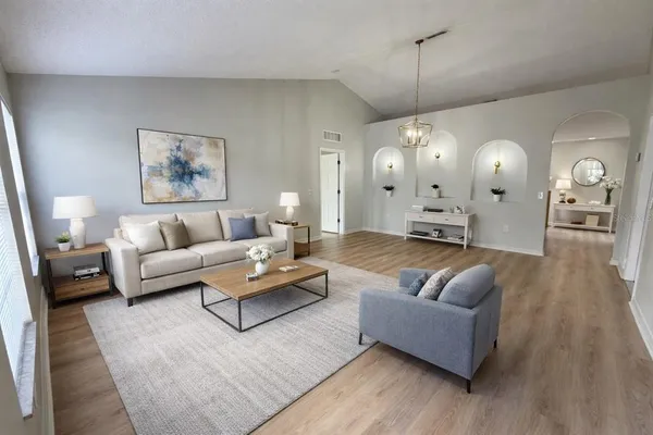 a living room with furniture and wooden floor