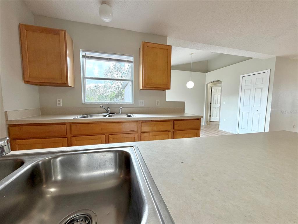12052 Villa Road Spring Hill, FL 34609 - Photo 21 of 50 a kitchen with a refrigerator and a sink