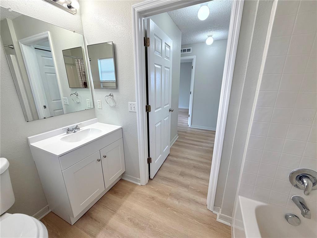 12052 Villa Road Spring Hill, FL 34609 - Photo 26 of 50 a bathroom with a sink and mirror with toilet