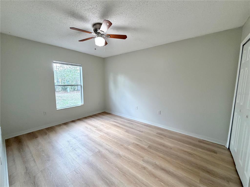 12052 Villa Road Spring Hill, FL 34609 - Photo 29 of 50 wooden floor in an empty room with a window