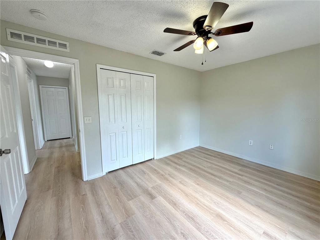 12052 Villa Road Spring Hill, FL 34609 - Photo 31 of 50 wooden floor in an empty room with a window