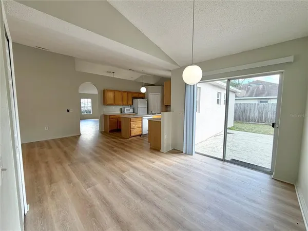 a view of a room with wooden floor and a fireplace