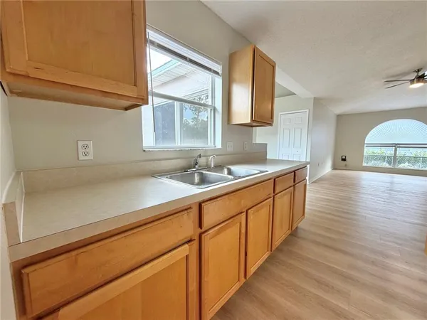 a spacious bathroom with stainless steel appliances granite countertop a sink and a wooden floors