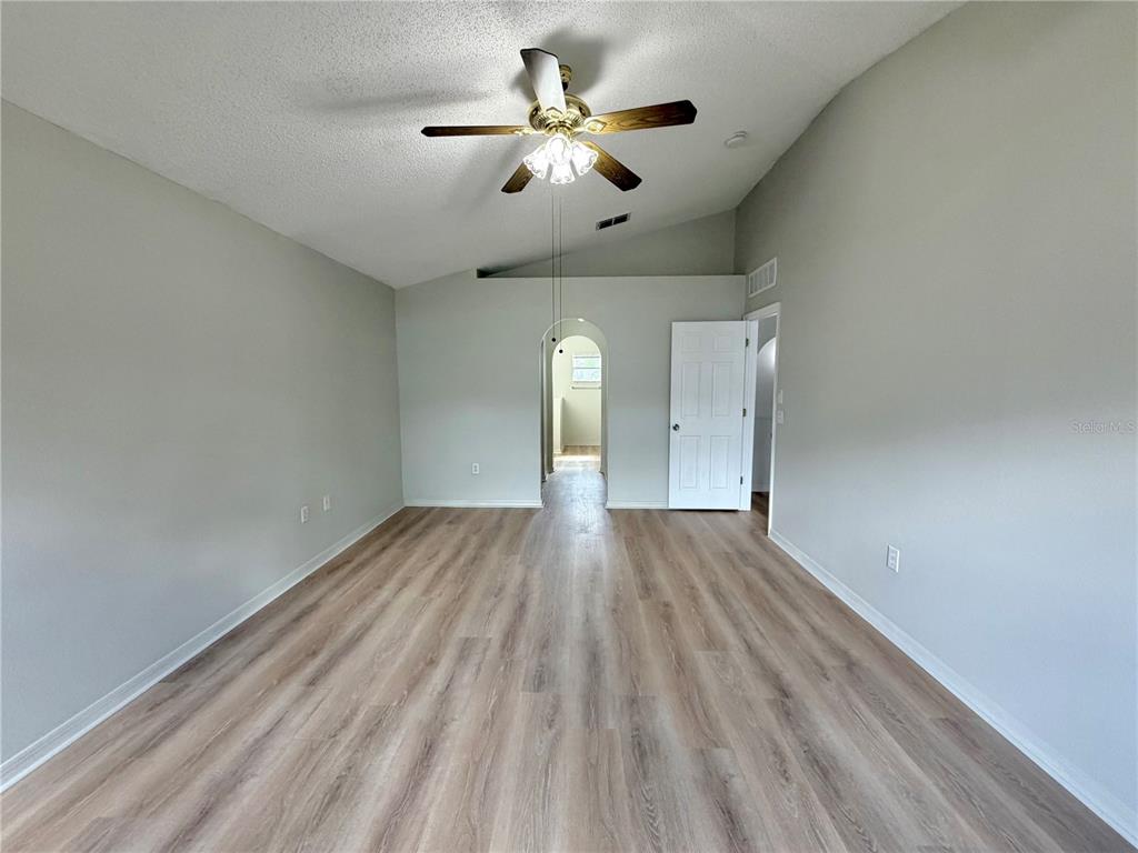 12052 Villa Road Spring Hill, FL 34609 - Photo 39 of 50 wooden floor in an empty room with a window