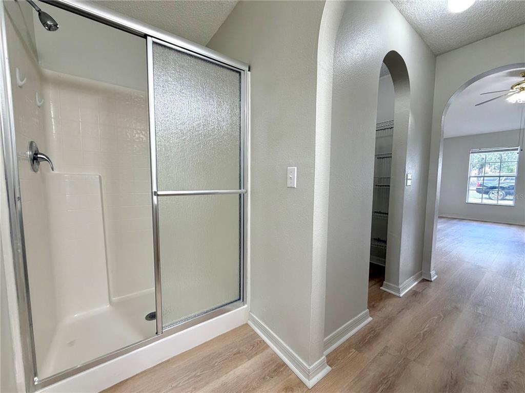 12052 Villa Road Spring Hill, FL 34609 - Photo 49 of 50 a view of an empty room with wooden floor and a bathroom