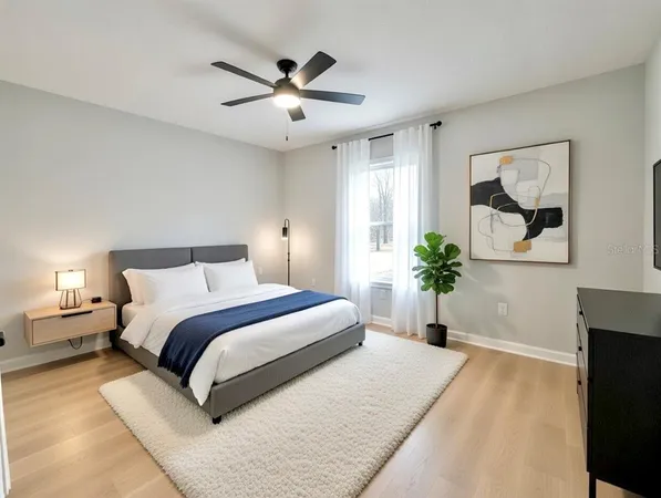 a bedroom with a large bed and a chandelier