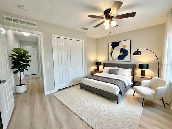 a bedroom with a bed and ceiling fan