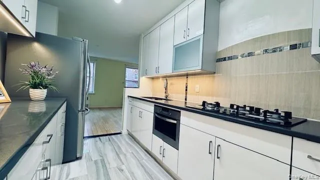 a kitchen with granite countertop a sink and cabinets