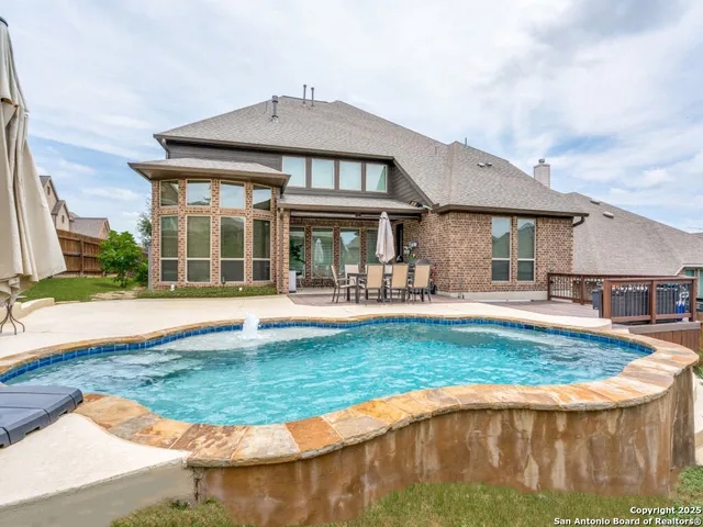 a view of a house with swimming pool and a yard