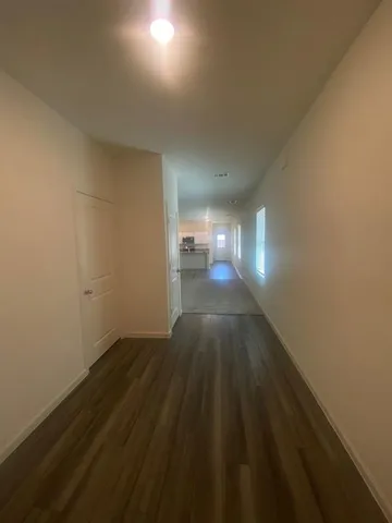 a view of an empty room and wooden floor