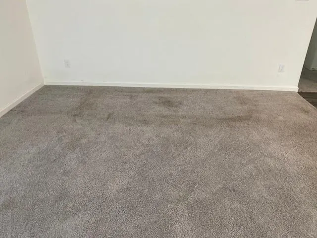 a open kitchen with stainless steel appliances a large counter top a refrigerator a stove a sink and a fireplace