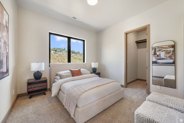 10646 North Reflection Ridge Hideout, UT 84036 - Photo 23 of 43 Bedroom featuring large horizontal windows with black framing, neutral-toned walls, and plush carpeting