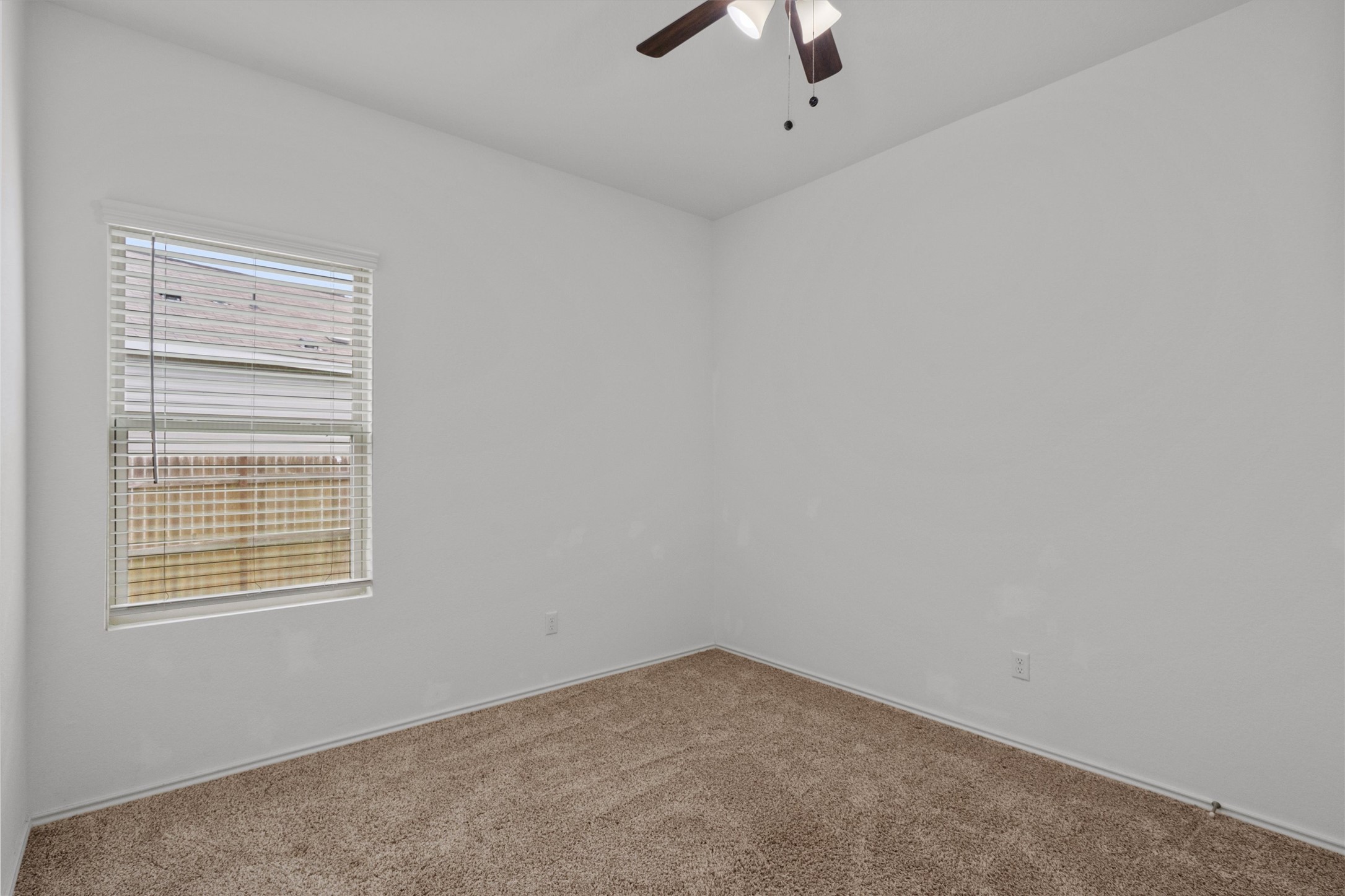 791 Circle Way Jarrell, TX 76537 - Photo 26 of 36 Carpeted room featuring a ceiling fan with integrated lighting, a window with horizontal blinds, and neutral wall tones