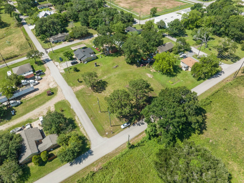 an aerial view of residential house with outdoor space and trees all around