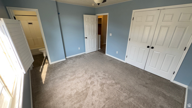 3547 East Golden Eagle Road Eagle Mountain, UT 84005 - Photo 19 of 47 Unfurnished bedroom featuring carpet, a closet, and ensuite bathroom