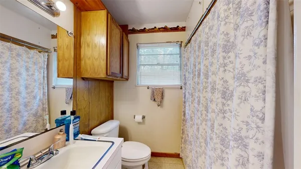 a bathroom with a toilet a sink and a shower