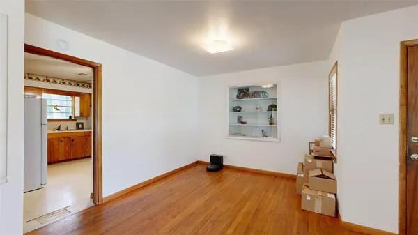 a view of a room with wooden floor and cabinet
