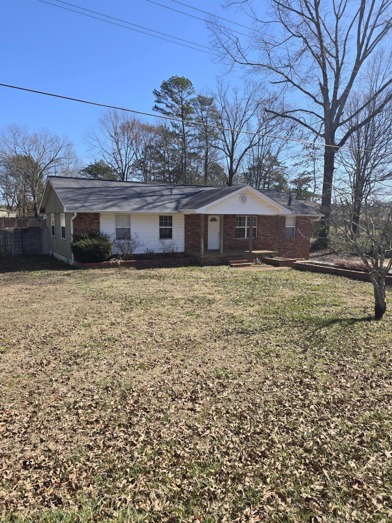 6063 Spring Place Road Southeast Cleveland, TN 37323 - Photo 1 of 44 a front view of a house with a yard