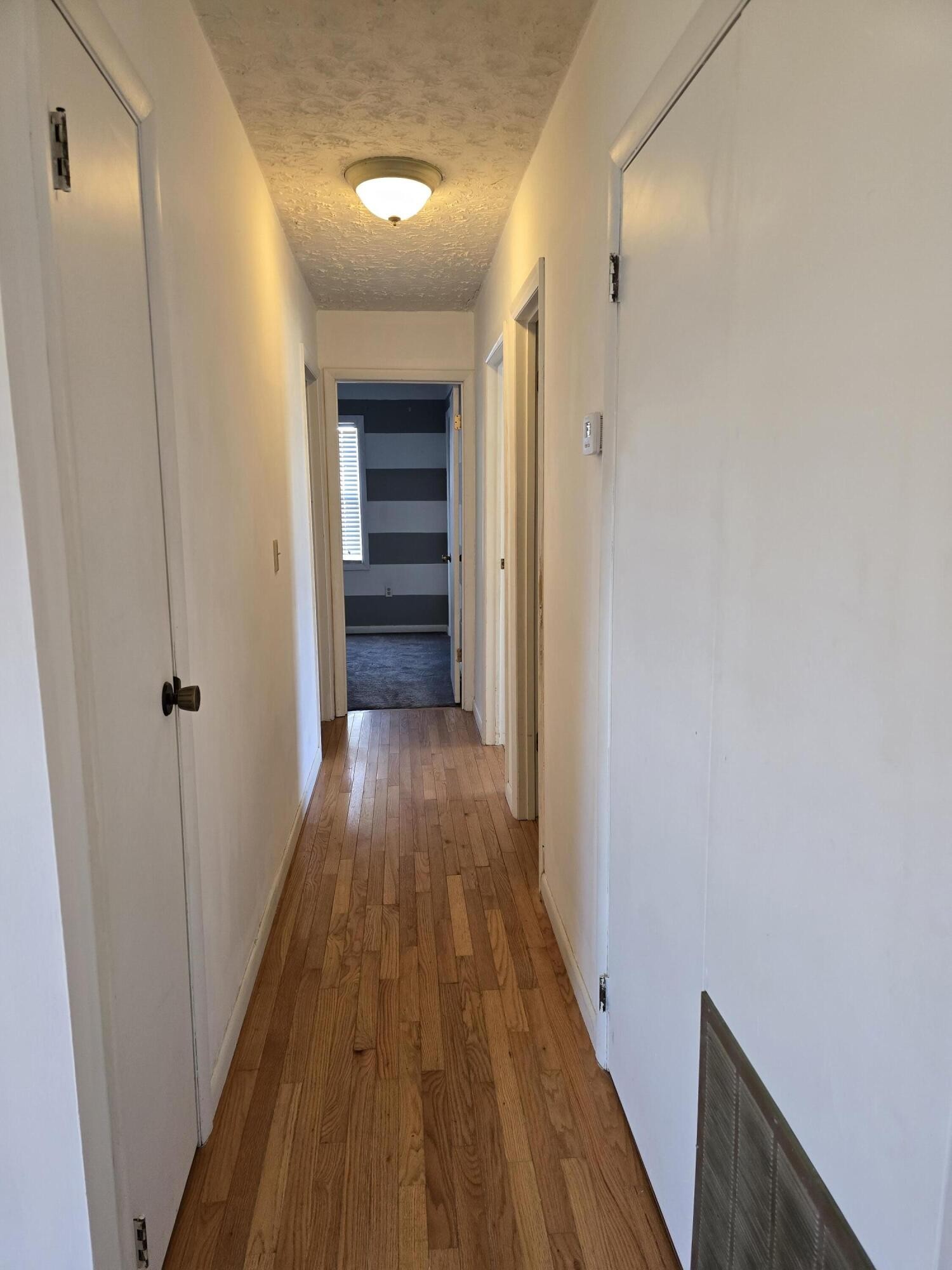 6063 Spring Place Road Southeast Cleveland, TN 37323 - Photo 15 of 44 a view of a hallway with wooden floor and staircase