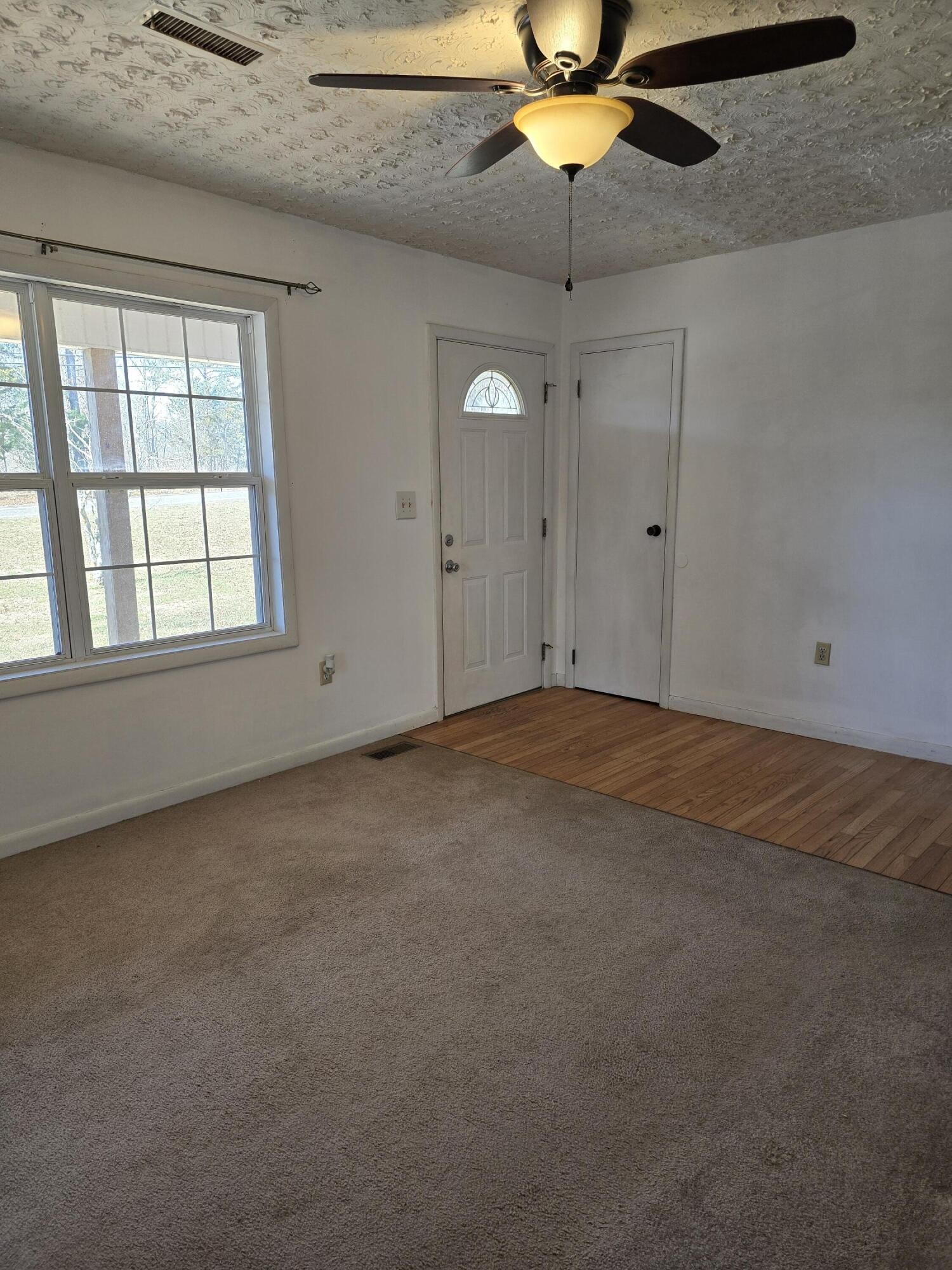6063 Spring Place Road Southeast Cleveland, TN 37323 - Photo 4 of 44 an empty room with a window and a fan