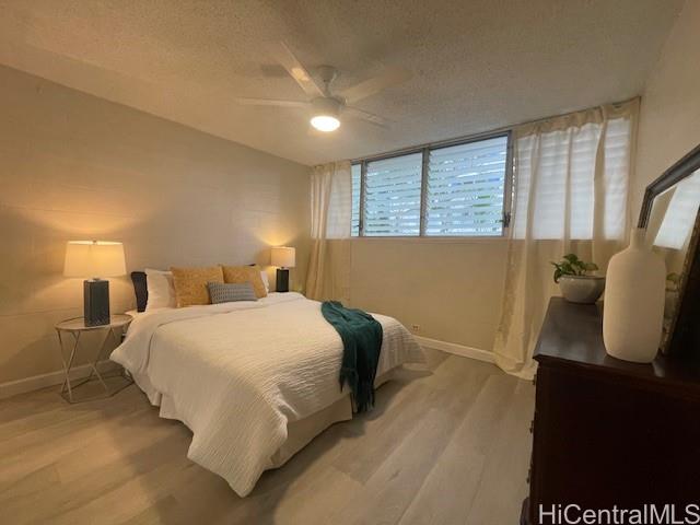 1867 Kaioʻo Drive, Unit 307 Honolulu, HI 96815 - Photo 1 of 1 a bedroom with a bed and wooden floor