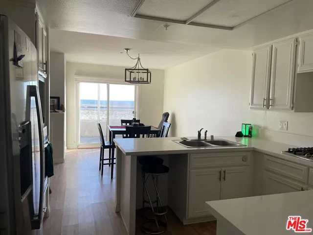 a kitchen with kitchen island a sink stove and refrigerator