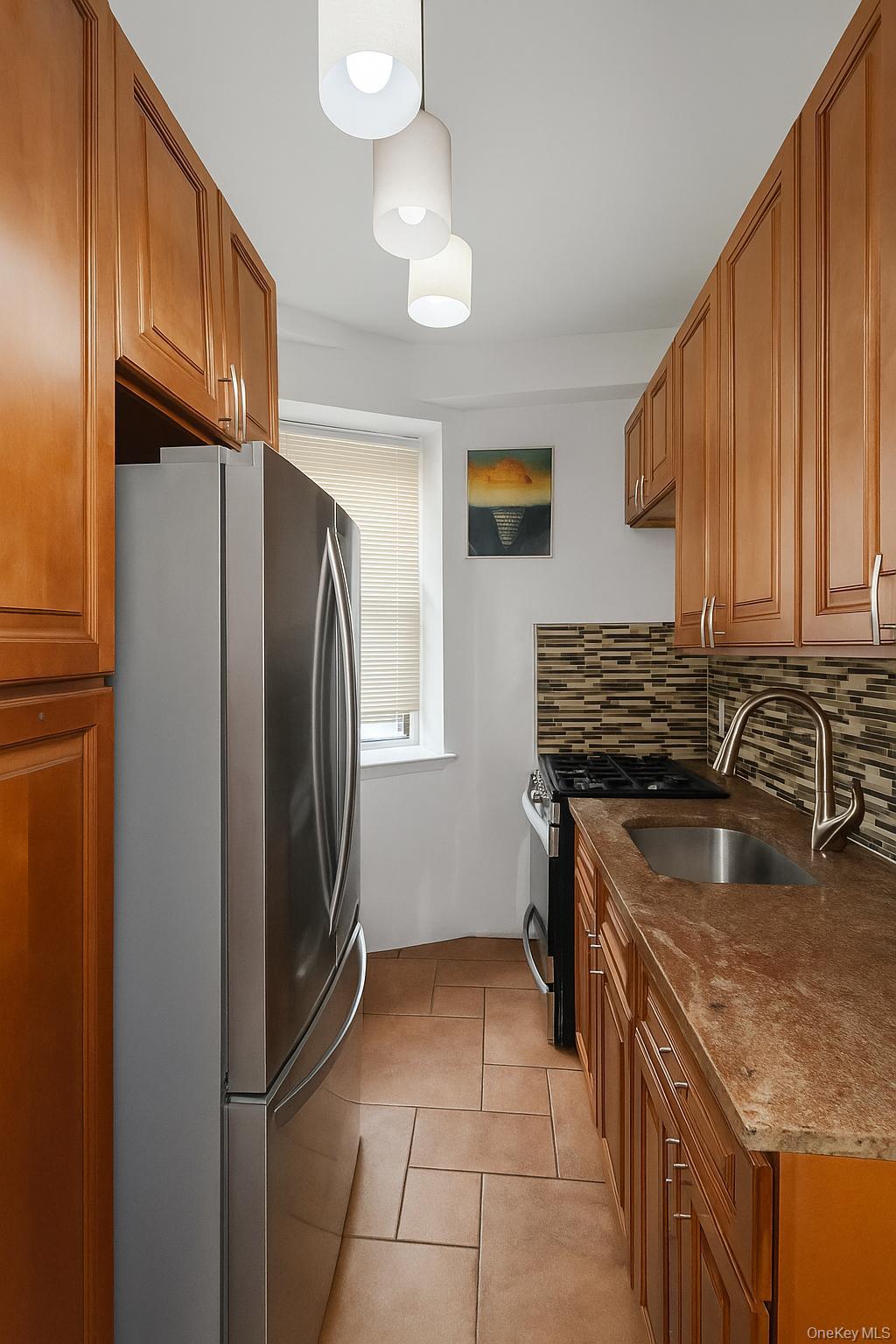 800 Grand Concourse, Unit LEN Bronx, NY 10451 - Photo 3 of 10 a kitchen with a sink a stove and a refrigerator
