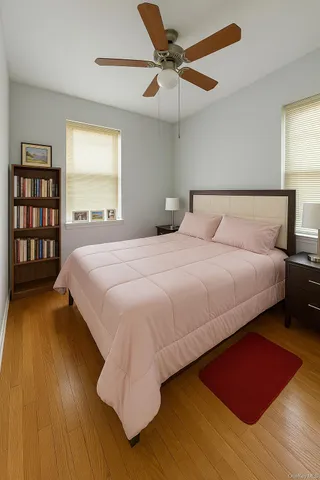 a bedroom with a bed lamp closet and large window