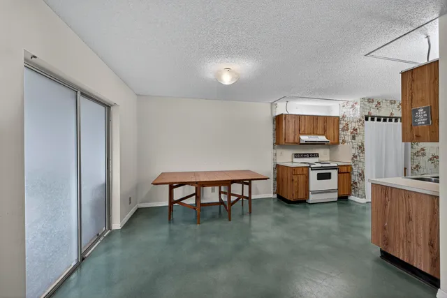 a kitchen with stainless steel appliances a refrigerator and a stove top oven