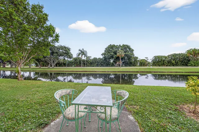 a view of a chairs and table on the lake