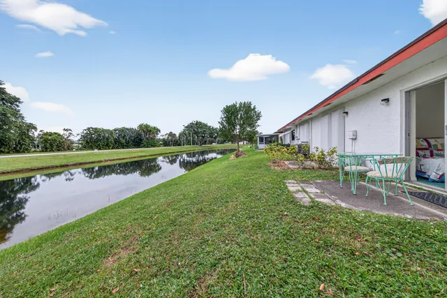 a view of a house with a yard and a lake view