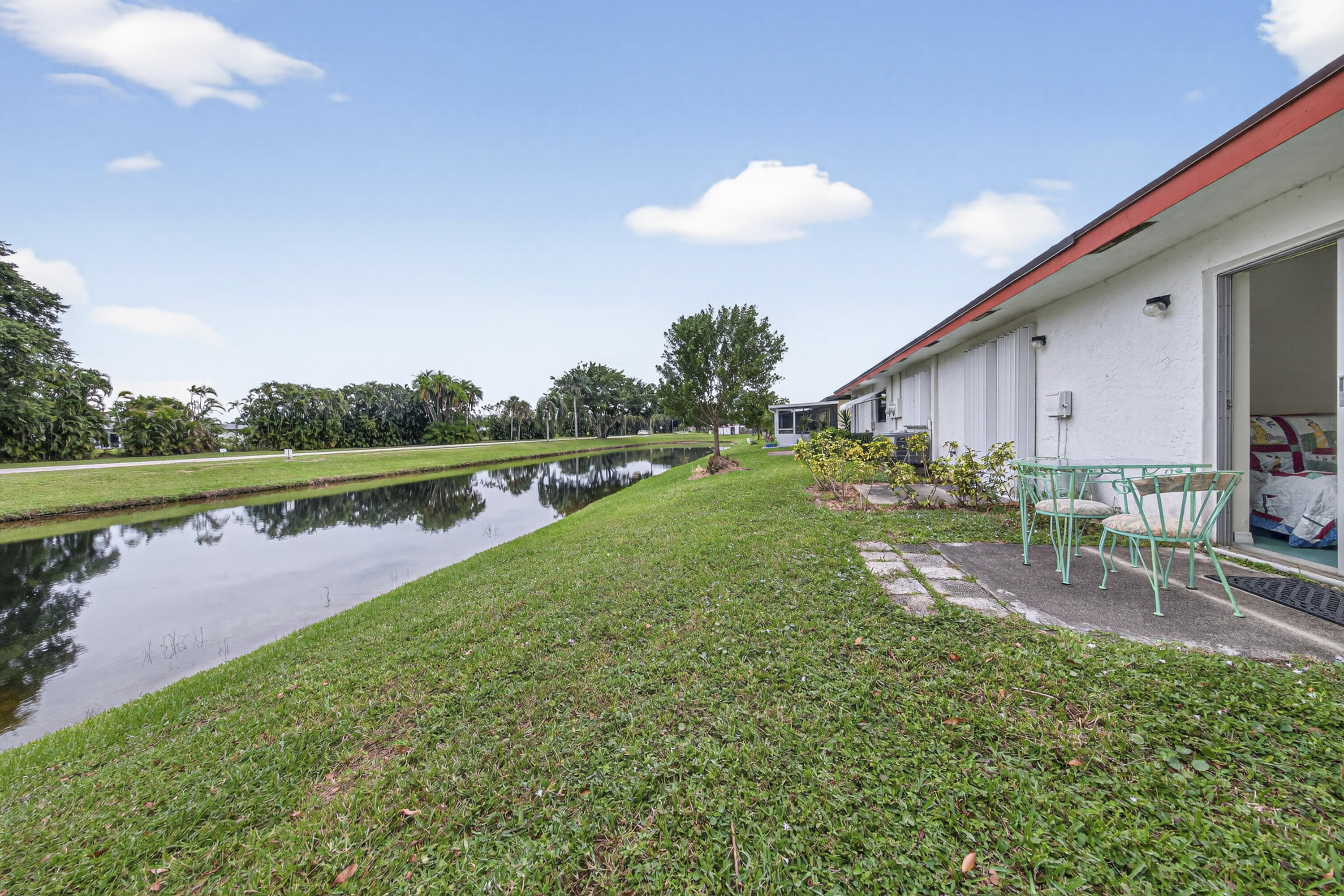 14236 Campanelli Drive Delray Beach, FL 33484 - Photo 29 of 33 a view of a house with a yard and a lake view