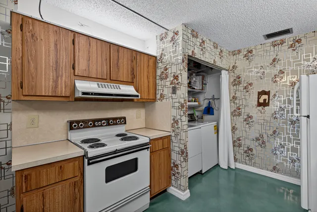 a kitchen with stainless steel appliances granite countertop a stove a refrigerator and a microwave