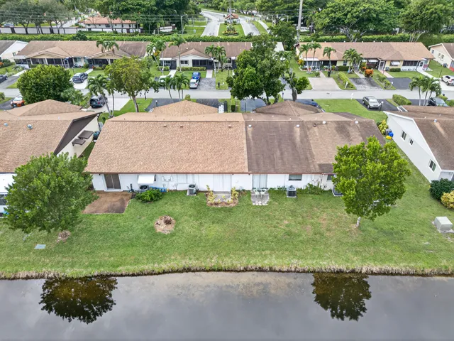 an aerial view of a house with a garden and a yard
