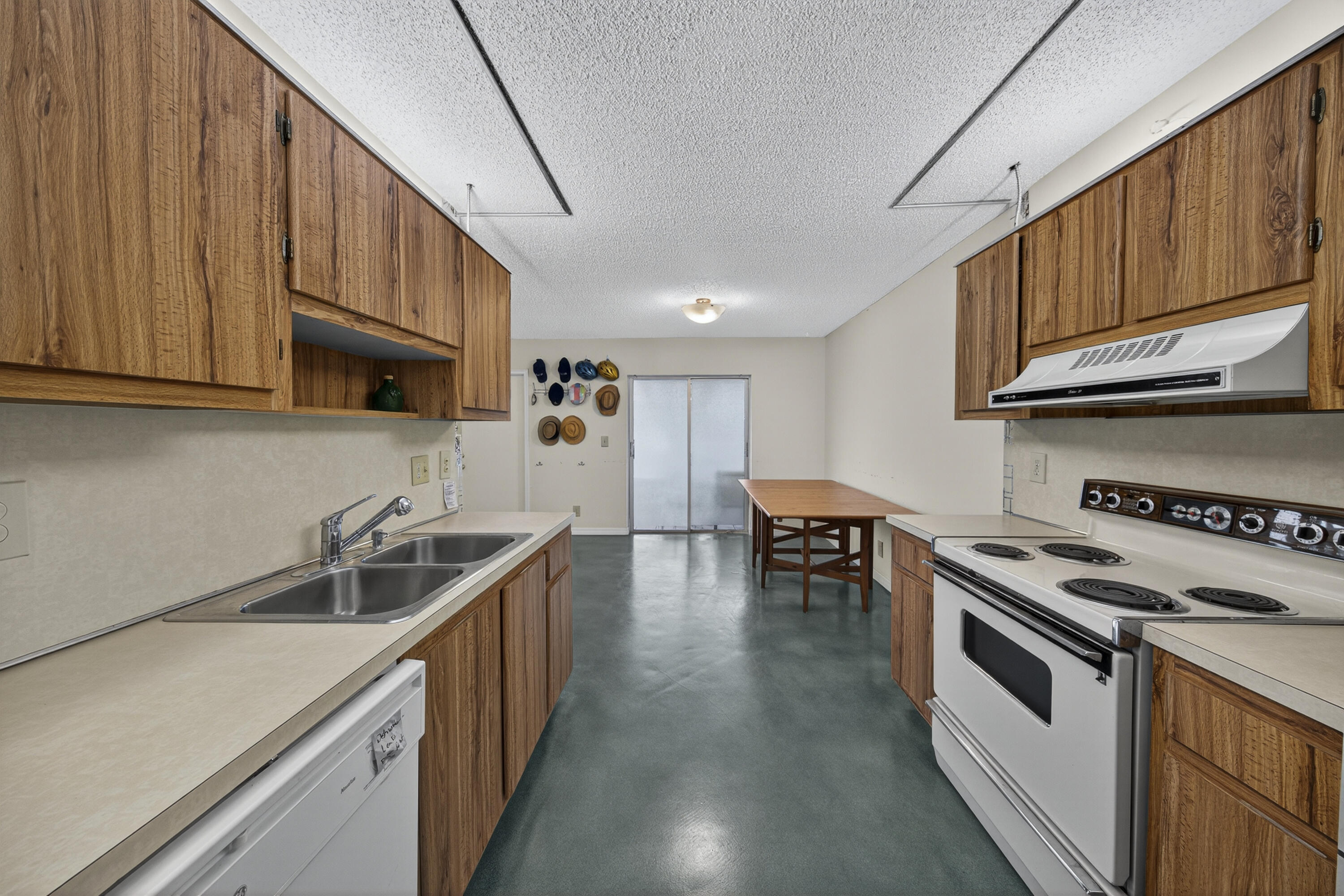 14236 Campanelli Drive Delray Beach, FL 33484 - Photo 6 of 33 a kitchen with stainless steel appliances granite countertop a sink a stove and a wooden cabinets